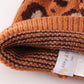 Brown pompom leopard cable beanie